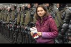Activist Olga Misik holding a copy of the Constitution of the Russian Federation stands in front of riot policemen during a protest in Moscow on August 10, 2019