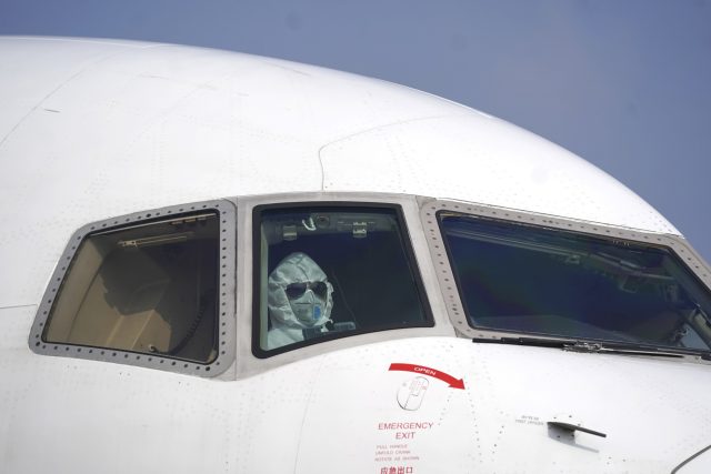Pilot nákladního letadla na letišti ve Wu-chanu | foto:  Cheng Min,  ČTK/AP