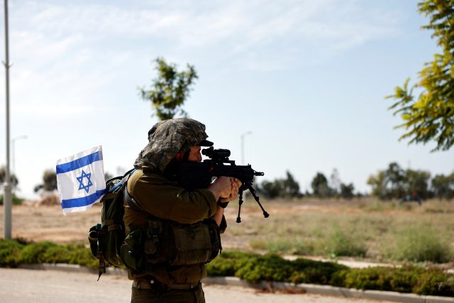 Izraelský voják zajišťuje oblast po smrtícím průniku ozbrojenců Hamásu z pásma Gazy v kibucu Kissufim na jihu Izraele | foto: Amir Cohen,  Reuters